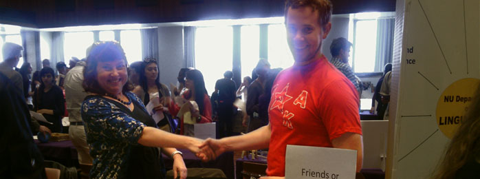 Clare Cavanagh handshake with student at fair